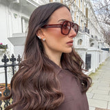 Model wearing large silver CZ diamond studs — statement stud earrings UK