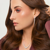 Model wearing silver skeleton stud earrings. Demi-fine sterling silver statement earrings