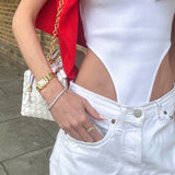 Model wearing gold  tennis bracelet. demi-fine diamond-look bracelet UK