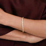 Model wearing gold  tennis bracelet. demi-fine diamond-look bracelet UK