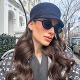 Model wearing large silver CZ diamond studs — statement stud earrings UK