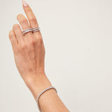 Model wearing silver tennis bracelet. demi-fine diamond-look bracelet UK