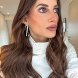 Elegant silver cascading drop earrings worn by model — demi-fine CZ stud earrings London